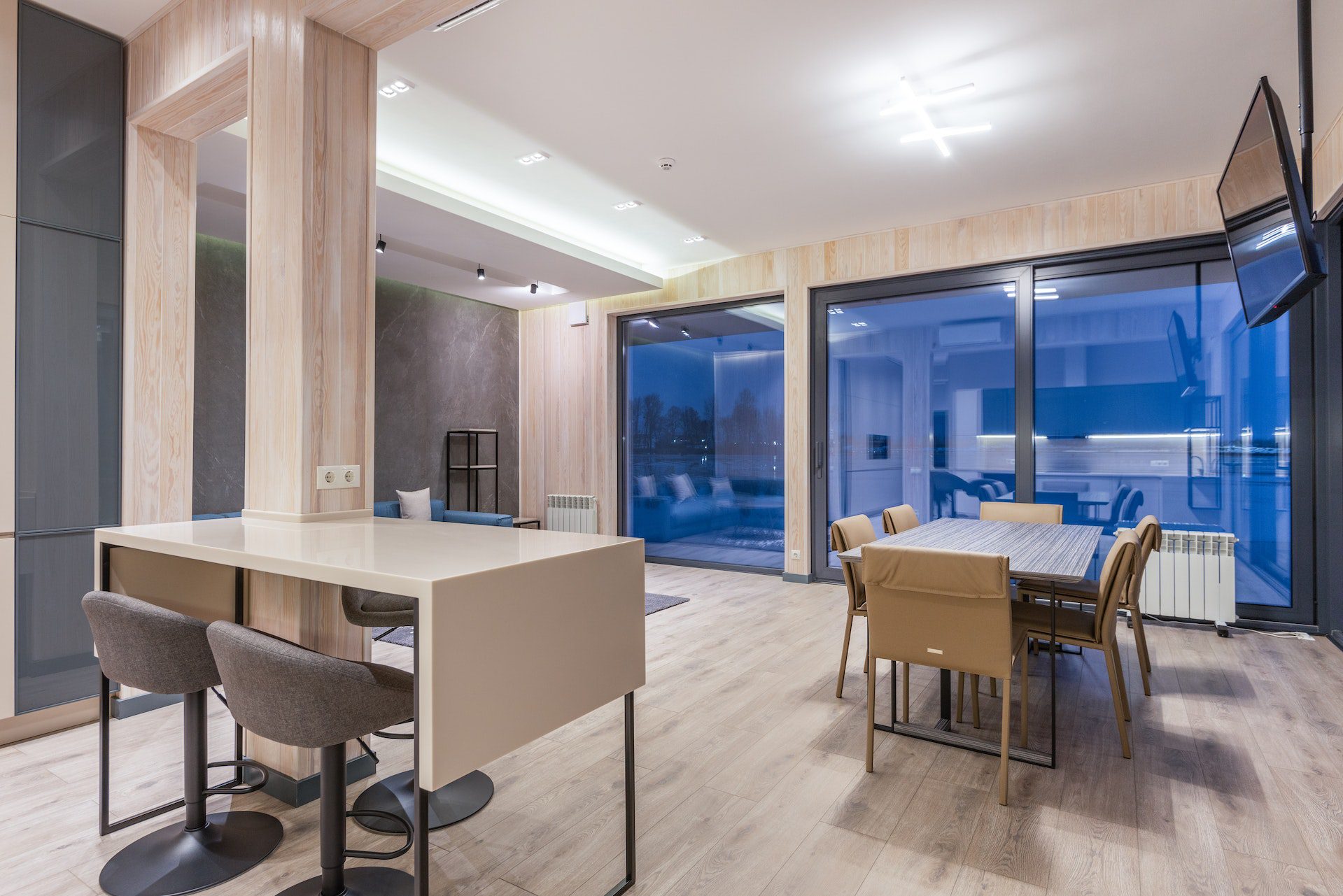 Interior of contemporary house with wooden furniture and glass panoramic windows<br />
